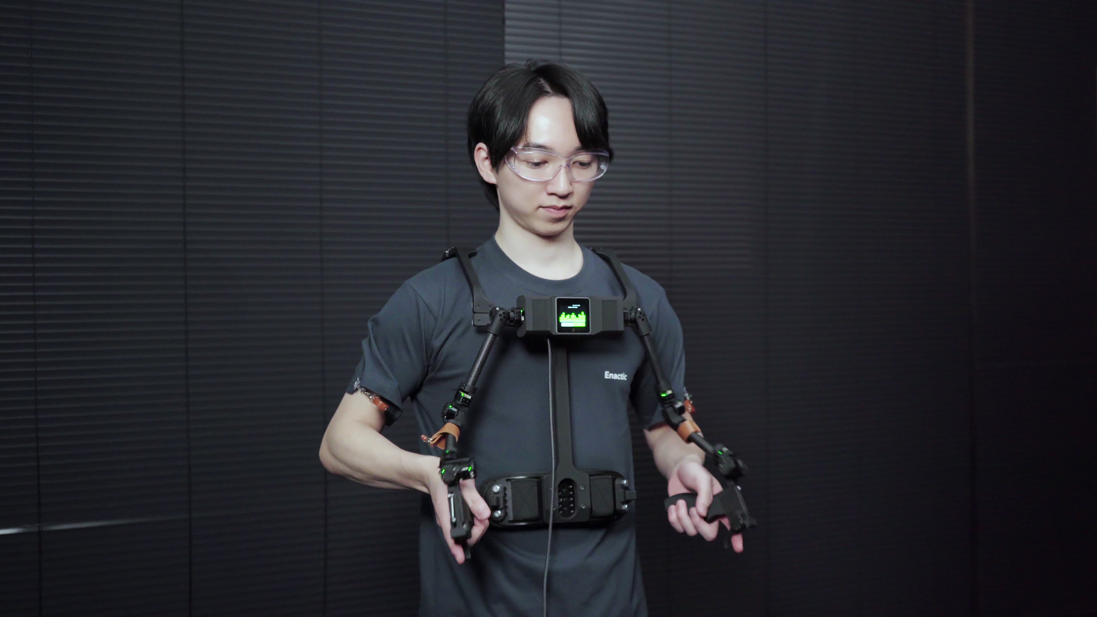 Operator wearing the OpenArm KER shoulder-mounted teaching device
